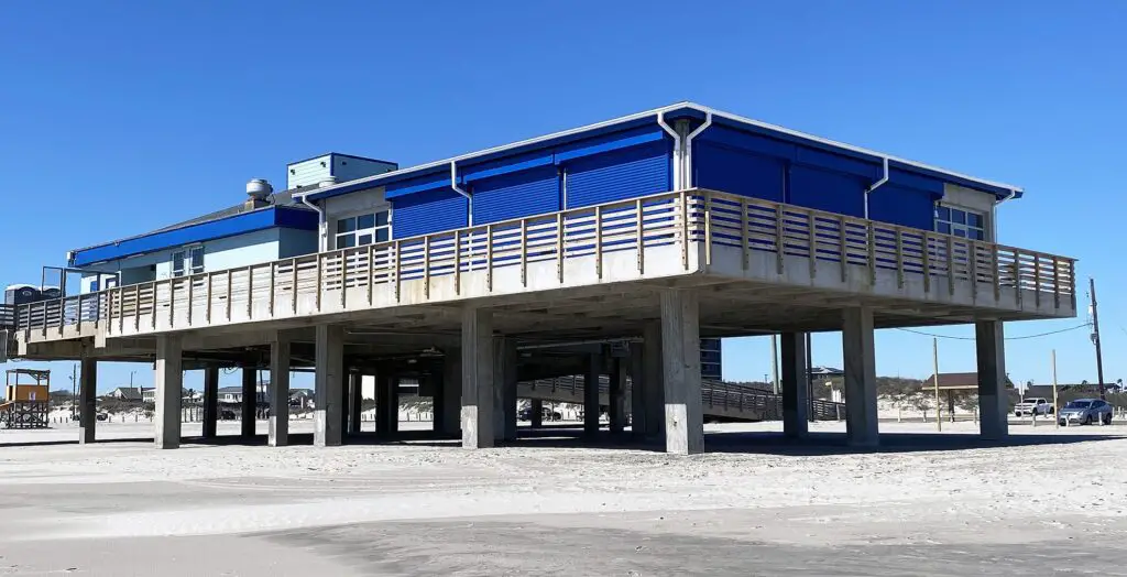 Lined with garage doors, the new observation tower stands on the beach at Horace Caldwell Pier, next to a structure that holds the Keepers shop. Plans are in place to install displays on coastal ecology and cultural history inside. Staff photo by Dan Parker