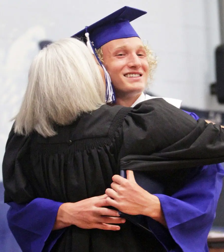 Upper left: Deana Erdner gets a hug from her son, graduate Ian McClelland, after she handed him his diploma on stage during the ceremonies. Erdner is the president of the Port Aransas Independent School District Board of Trustees. Staff photo by Dan Parker